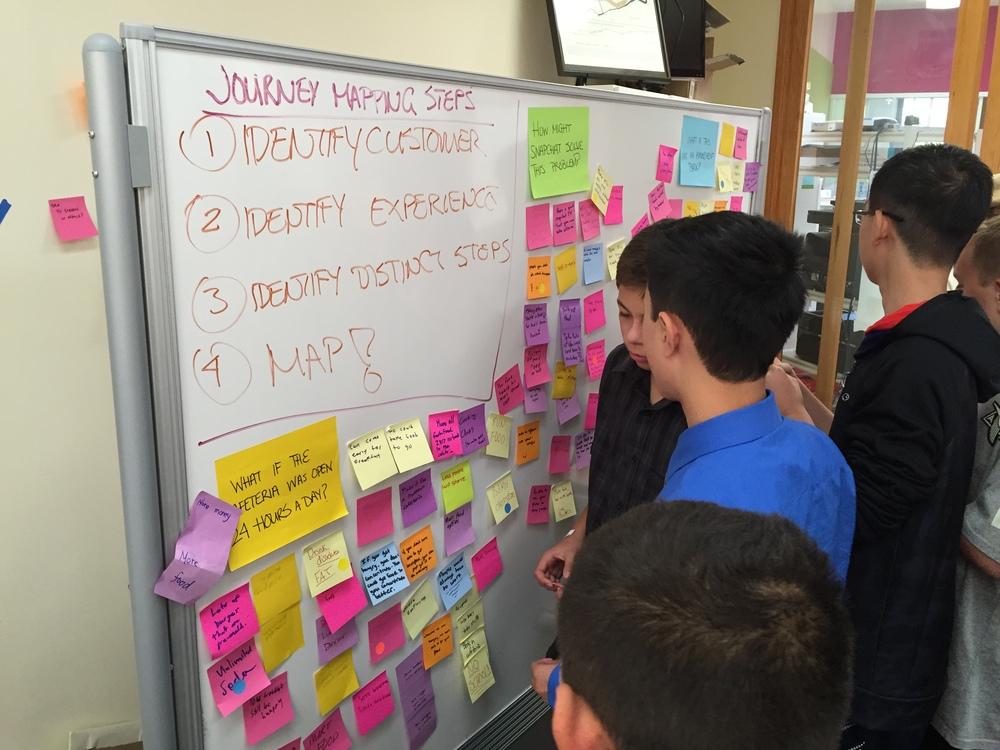  Students begin to dot vote for their favorite ideas following the brainstorm session. 